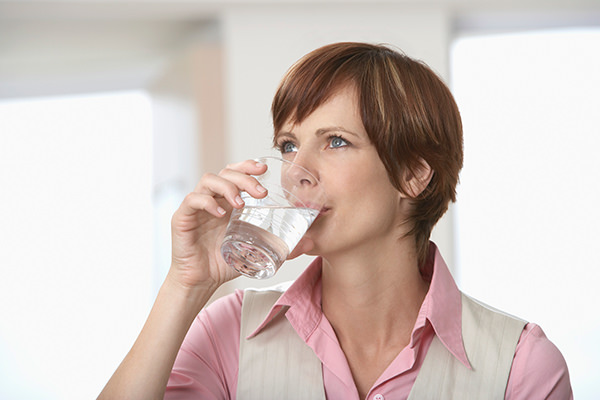 Woman drinking a glass of clean fresh water